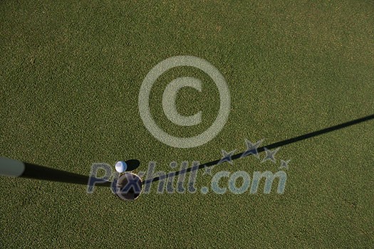 top view of golf ball on edge of course hole representing achivement and success business concept top view of golf ball on edge of course hole representing achivement and success business concept