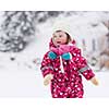 portrait of happy smiling little girl child outdoors having fun and playing on snowy winter day