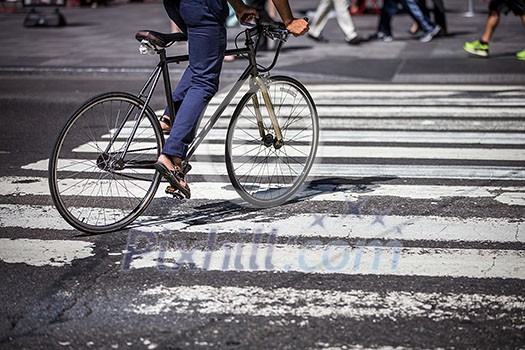 Man on a bike on a crossing in Manhattan, NYC Man on a bike on a crossing in Manhattan, NYC