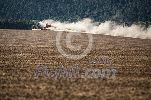 Tractor plowing a dry farm field Tractor plowing a dry farm field