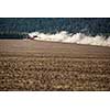 Tractor plowing a dry farm field