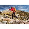 Pretty, young female hiker going uphill