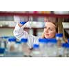 Portrait of a female researcher doing research in a lab (shallow DOF; color toned image)