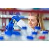 Portrait of a female researcher doing research in a lab (shallow DOF; color toned image)