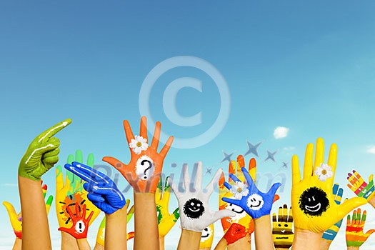 Human hands in colorful paint showing symbols Human hands in colorful paint showing symbols