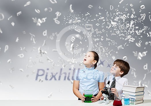 Two cute children at chemistry lesson making experiments Two cute children at chemistry lesson making experiments