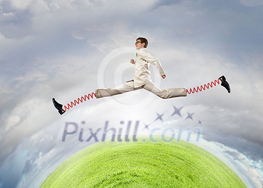 Businessman in suit jumping with big springs on feet