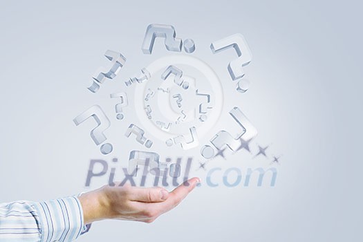 Close up of businessman hand holding glass question symbols Close up of businessman hand holding glass question symbols