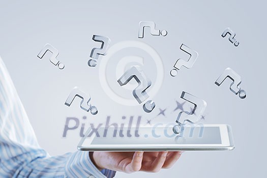 Close up of businessman hand holding tablet and glass symbols Close up of businessman hand holding tablet and glass symbols