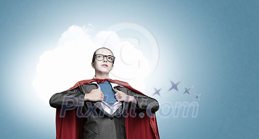 Businesswoman wearing red cape and opening her shirt like superhero Businesswoman wearing red cape and opening her shirt like superhero