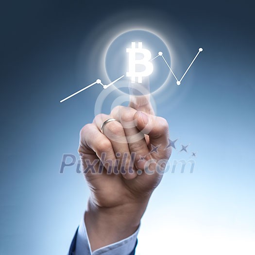 the hand of a man clicks Icon Bitcoin on virtual screen.Cryptocurrency graph on virtual screen. Business, Finance and technology concept. the hand of a man clicks Icon Bitcoin on virtual screen.Cryptocurrency graph on virtual screen. Business, Finance and technology concept.