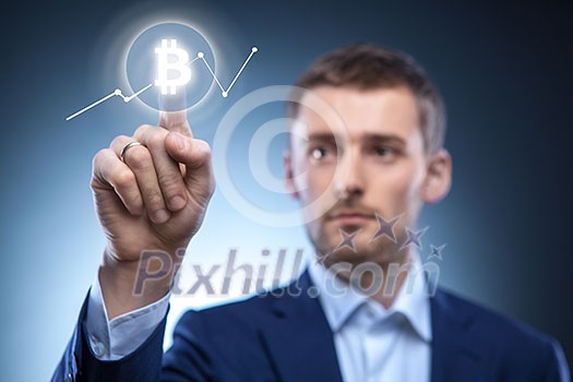 Graph of the crypto currency on the virtual screen, the man clicks on the bitcoin icon