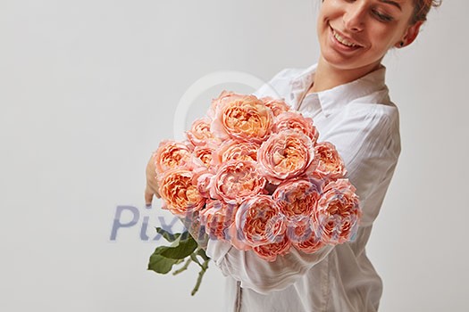 happy smiling girl holding a large bouquet of pink roses. valentine's day, mother's day happy smiling girl holding a large bouquet of pink roses. valentine's day, mother's day