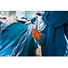 Knee surgery, Orthopedic Operation  - two surgeons performing a knee surgery on a patient (shallow DOF; color toned image)