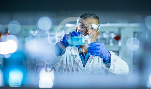 Senior male researcher carrying out scientific research in a lab (shallow DOF; color toned image)