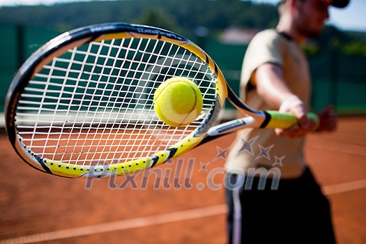 Tennis player in action on a tennis court Tennis player in action on a tennis court
