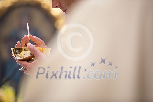 Priest' hands during a wedding ceremony/nuptial mass (shallow DOF; color toned image) Priest' hands during a wedding ceremony/nuptial mass (shallow DOF; color toned image)