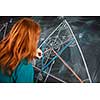 Portrait of a pretty young college student writing on the blackboard during a maths class (color toned image)