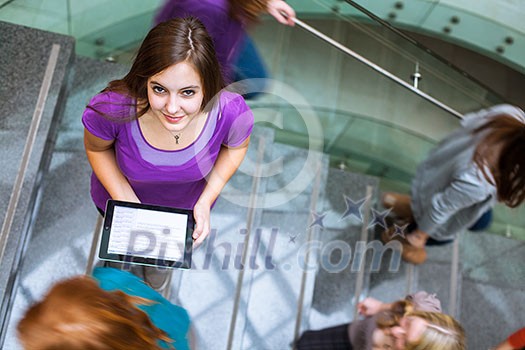 At the university/college - Students rushing up and down a busy stairway - confident pretty young female student looking upwards