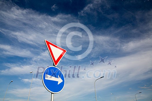 Road signs against lovely blue summer sky Road signs against lovely blue summer sky