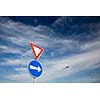 Road signs against lovely blue summer sky