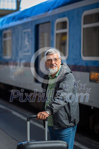 Handsome senior man taking a train, waiting for his family to pick him up (color toned image)