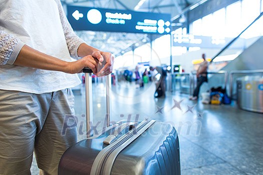 Young female passenger at the airport, waiting for her delayed flight