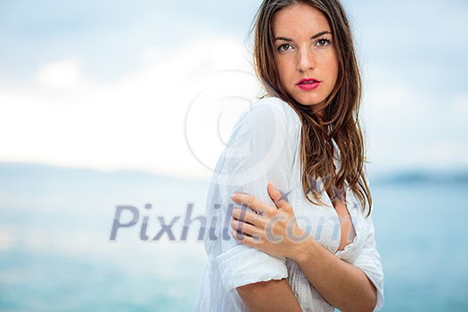 Woman relaxing at the beach with arms open enjoying her freedom,  independence, good health, time off.