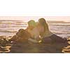 Couple With A Dog enjoying time  together On The Beach at autumn day