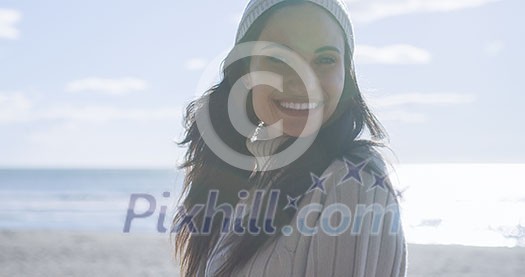 Portrait Of A Young Woman In Autumn Clothes Smiling On The Beach