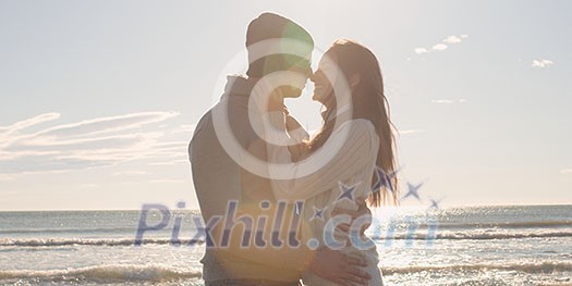 Cool Couple Laughing and hugging In Front Of Beach at beautiful autumn day Cool Couple Laughing and hugging In Front Of Beach at beautiful autumn day
