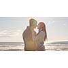 Cool Couple Laughing and hugging In Front Of Beach at beautiful autumn day