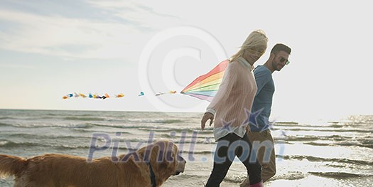 Couple Running On The Beach Holding Their Hands with dog On autmun day Couple Running On The Beach Holding Their Hands with dog On autmun day