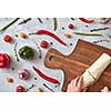 The girl cuts the finished burrito on a wooden board. Photo of a step-by-step cooking burrito. Top view, flat lay.