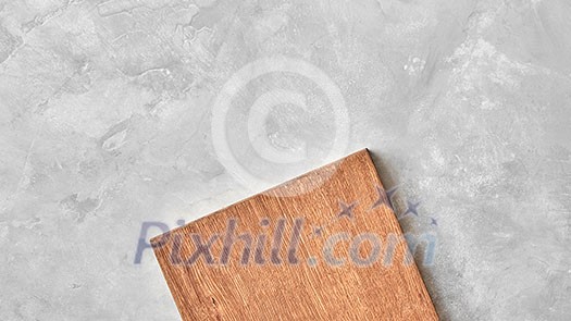 wood cutting board on a gray concrete background. Top view, flat lay