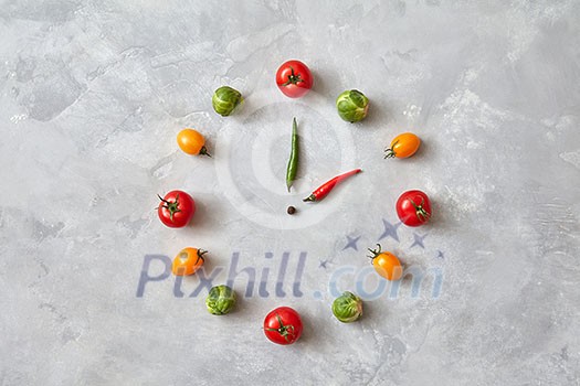 Watches made from tomatoes and Brussels sprouts. The concept of healthy eating. Dinner time. Top view, flat lay.