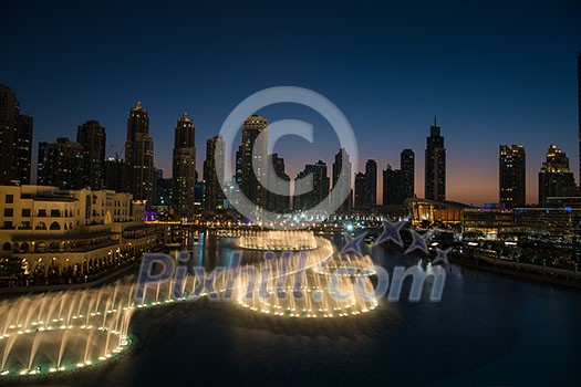 DUBAI UAE 31 JANUARY 2017 famous musical fountain in Dubai with skyscrapers in the background on a beautiful summer evening DUBAI UAE 31 JANUARY 2017 famous musical fountain in Dubai with skyscrapers in the background on a beautiful summer evening