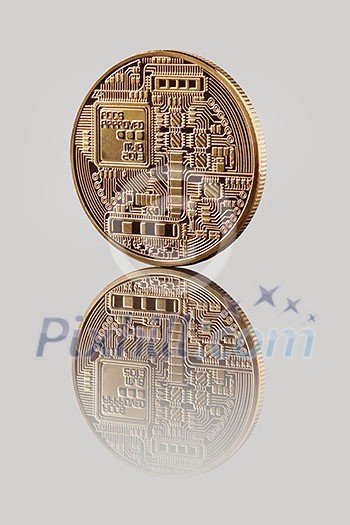 Gold Bitcoin Coin on a gray background. Reflection of the back side of the coin on a glossy background. Bitcoin cryptocurrency. Business concept.