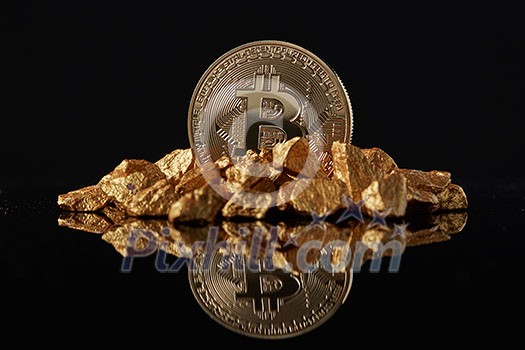 Golden Bitcoin Coin and mound of gold with reflection on a dark glossy background. Concept of financing Bitcoin cryptocurrency in Noble metal