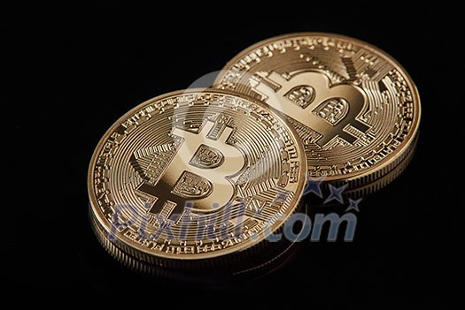 Gold bitcoin coin stacked against a dark background as a symbol of electronic currency. . Bitcoin cryptocurrency. Electronic money mining concept