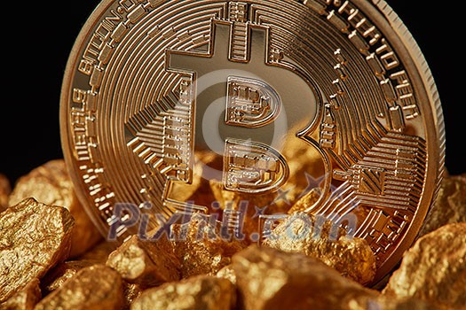 Closeup of gold nugget and Gold Bitcoin Coin on black background . Bitcoin as desirable as digital gold concept. Bitcoin cryptocurrency. Closeup of gold nugget and Gold Bitcoin Coin on black background . Bitcoin as desirable as digital gold concept. Bitcoin cryptocurrency.