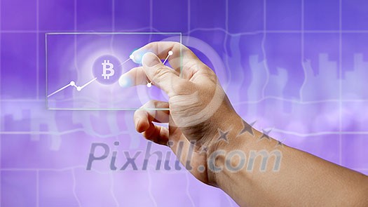 A businessman holds a glass screen with a bitcoin symbol and a crypto currency graph on the ultraviolet background of the city. Business, Finance and technology concept can be used for video or site cover