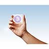 Transparent digital screen is held by a male hand with a bitcoin icon on a blue background. Business, technology and cryptocurrency concept