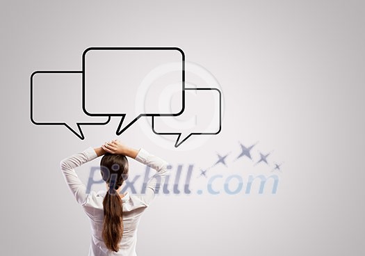 Rear view of businesswoman and speech bubbles above head Rear view of businesswoman and speech bubbles above head