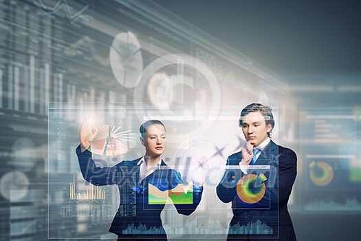 Businessman and businesswoman touching icon of digital screen Businessman and businesswoman touching icon of digital screen