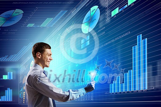 Young businessman with tablet in hands against digital background
