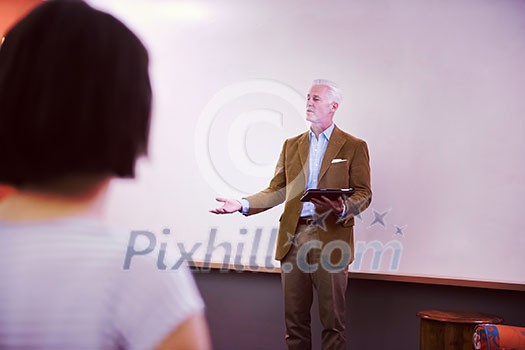 group of students study with professor in modern school classroom