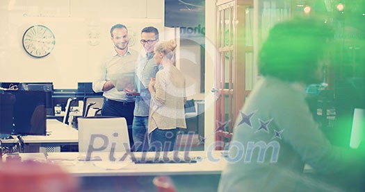 Group of a young business people discussing business plan at modern startup office building Group of a young business people discussing business plan at modern startup office building