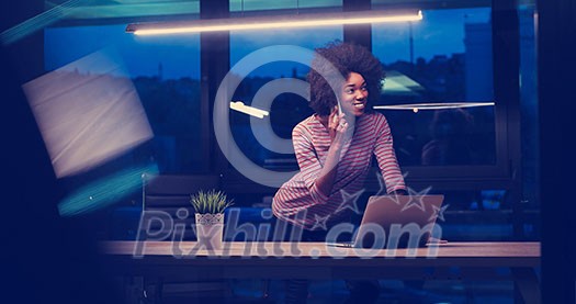 Young african american female Entrepreneur Freelancer Working Using A Laptop In night Coworking space