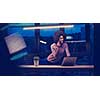 Young african american female Entrepreneur Freelancer Working Using A Laptop In night Coworking space
